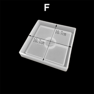 May include: A clear silicone mold for resin casting, shaped like a square with a smaller square inside. The mold measures 10.7 inches by 10.7 inches.