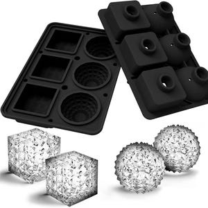 May include: A white ceramic mug with a black handle and the text "But First, Coffee" in a bold, black font. The mug is set against a blurred background, suggesting a cozy setting.