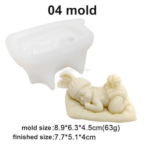 May include: A white silicone mould for making a sleeping baby figurine. The mould is 8.9 cm by 6.3 cm by 4.5 cm and weighs 63 grams. The finished figurine is 7.7 cm by 5.1 cm by 4 cm.
