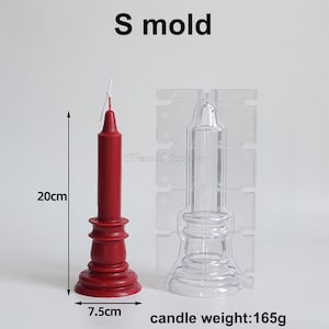 May include: A red pillar candle with a base and a clear plastic mold for making candles. The candle is 20 cm tall and 7.5 cm wide. The candle weighs 165 grams. The mold is labeled "S mold".