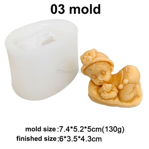 May include: A silicone mould for making a baby figurine. The mould is white and oval shaped. The finished figurine is 6 inches by 3.5 inches by 4.3 inches. The mould size is 7.4 cm by 5.2 cm by 5 cm.