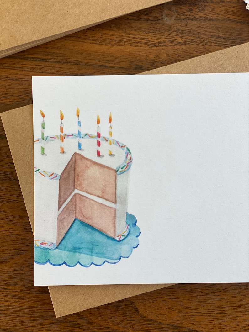 May include: A watercolour illustration of a birthday cake with blue icing and colourful sprinkles. The cake has a slice cut out and there are five lit candles on top.