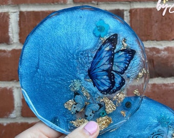 Dark blue and gold coaster with dried flowers and butterfly inserts