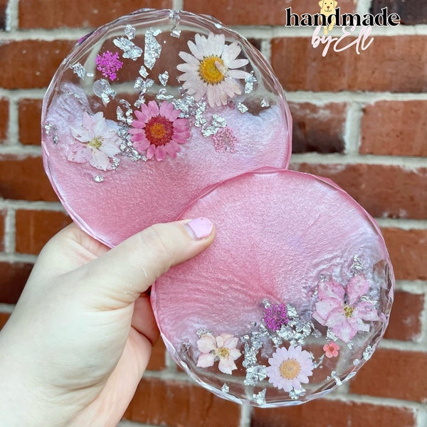 Pink and silver resin coaster with dried flowers