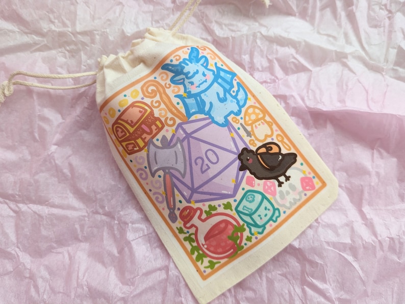 May include: A white drawstring bag with a colorful illustration of a 20-sided die, a dragon, a chest, a crow, and other fantasy-themed elements. The bag is perfect for storing dice or other small items.