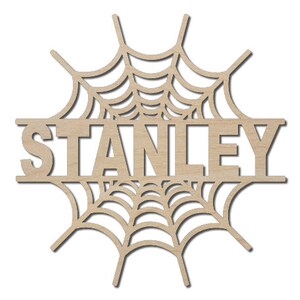 May include: A wooden cutout of a spiderweb with the name "STANLEY" in the center. The cutout is a popular Halloween decoration.