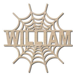 May include: Wooden cutout of a spiderweb with the name "WILLIAM" in the center. The cutout is designed for a Halloween decoration.