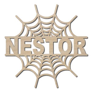 May include: A wooden cutout of a spiderweb with the name "NESTOR" in the center. The cutout is designed for crafting and decorating.