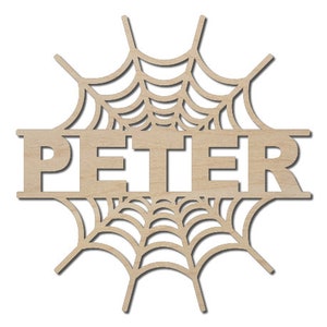 May include: A wooden cutout of a spider web with the name "PETER" in the center. The cutout is a light brown color and is perfect for decorating for Halloween.