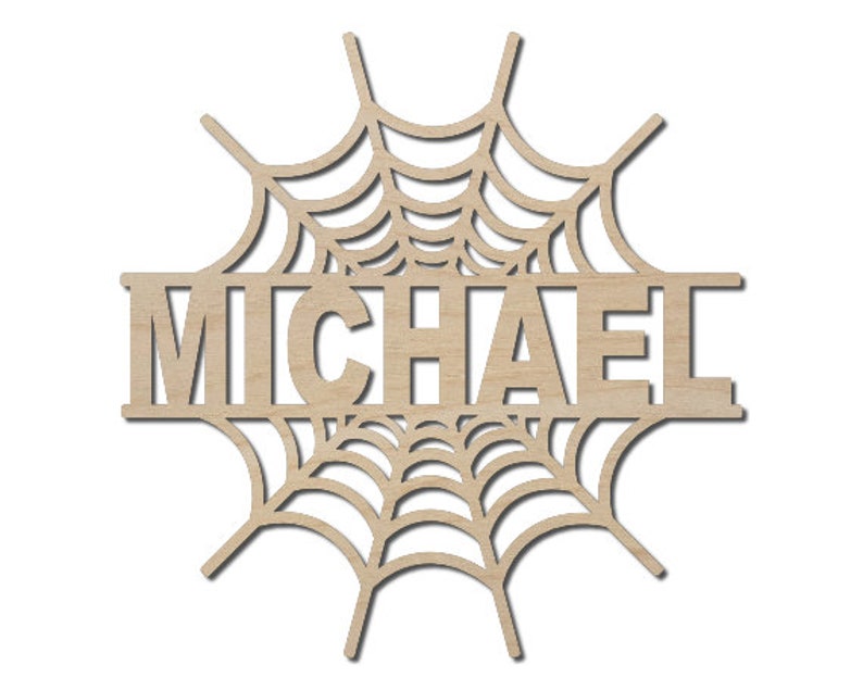 May include: A wooden cutout of a spider web with the name "MICHAEL" in the center. The cutout is designed for a Halloween decoration or personalized gift.
