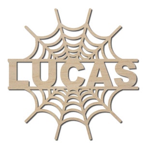 May include: Wooden cutout of a spiderweb with the name "LUCAS" in the center. The cutout is a popular Halloween decoration.