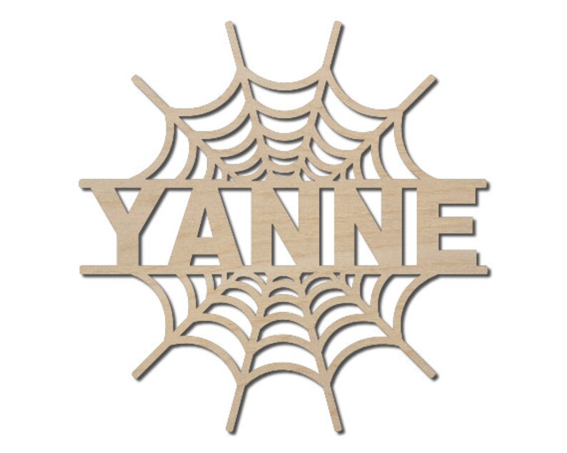 May include: Wooden cutout of a spiderweb with the name "YANNIE" in the center.