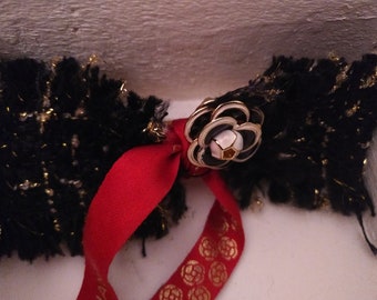 Black boucle with gold lurex thread and red ribbon and camelia accessory hairclip