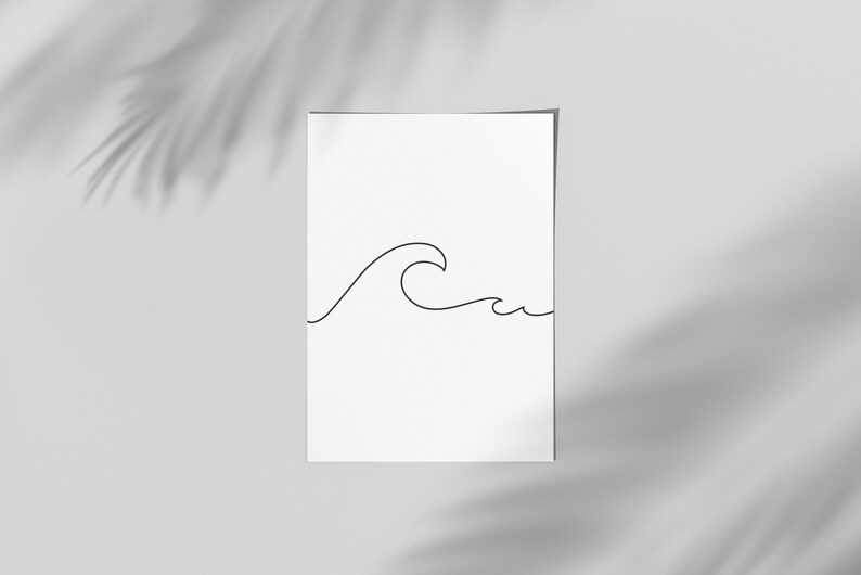 May include: A minimalist art print featuring a black line drawing of a wave on a white background. The artwork is simple and elegant, with a focus on the wave's form. The print is displayed against a neutral backdrop with shadows.