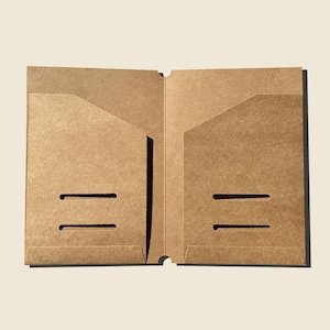 May include: Open, unfolded A5-sized brown paper folder. The folder has two pockets and two horizontal slits on the front. The text "A5" is printed at the bottom of the image.