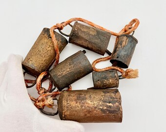 Antique Cow Bells on Cord Set of 6 Vintage Cattle Bells Rustic Farmhouse Cottagecore Wall Decor Old Hanging Bells