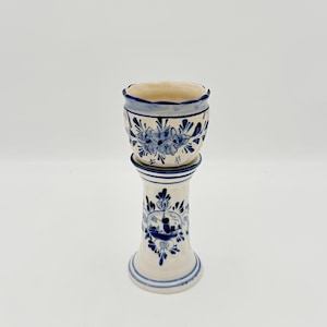 May include: A set of three ceramic mugs with a speckled, matte finish. The mugs are in shades of cream, light gray, and dark gray. Each mug has a simple, minimalist design and a rounded handle. The mugs are likely for coffee or tea.