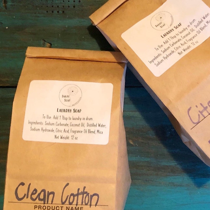 May include: Two brown paper bags with white labels. The labels have the text "DANDY SOAP" and "LAUNDRY SOAP" with instructions for use and ingredients. The bags are labeled "Clean Cotton" and "Citr".