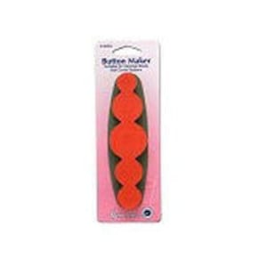 May include: A pack of five orange rubber buttons for sewing or crafts. The buttons are in a row on a white card with the text "Button Naturals" and "Sewing Buttons" printed on it.
