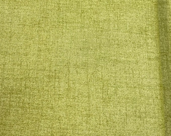 May include: A close-up of a textured fabric in a light green color. The fabric has a subtle woven pattern.