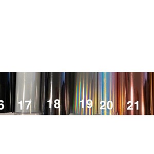 May include: A row of 9 different colored vinyl samples, numbered 15 through 23. The samples are iridescent, metallic, and matte.