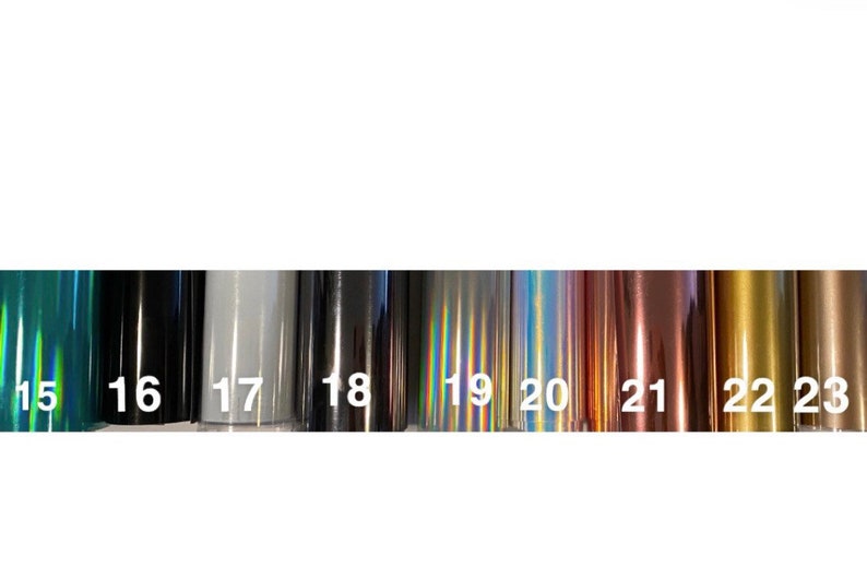 May include: A row of 9 different colored vinyl samples, numbered 15 through 23. The samples are iridescent, metallic, and matte.