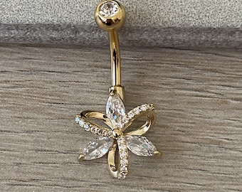 Piercing para el ombligo de acero quirúrgico con circonitas cúbicas y flor dorada.