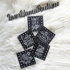May include: Five black leather patches with white text and a coffee cup design. The text on the patches reads: "Coffee pairs nicely with silence", "I don't give a sip", "Coffee before talkie", "May your coffee kick in before reality does", and "Coffee Crafting & Repeat".