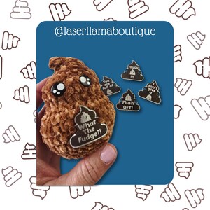 May include: A brown plush poop emoji with large eyes and the text "What The Fudge?!" on a white label.  Also, four small pins with poop emojis and phrases like "Flush OFF!" and "You are full of".