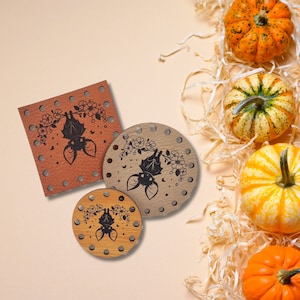 May include: Three wooden coasters with a bat design and floral accents. The coasters are brown, beige, and natural wood.
