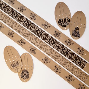 May include: Four brown leather belts with different patterns and designs. The belts feature various floral and geometric patterns, including a repeating pattern of small flowers, a larger floral pattern, a geometric pattern with a wave-like design, and a pattern of small squares. The belts also feature text, including "Stay Groovy" and "Gypsy Soul".
