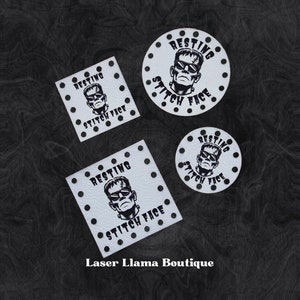 May include: Four white leather patches with black polka dots and a black and white illustration of a monster wearing sunglasses. The patches have the text "RESTING STITCH FACE" on them.