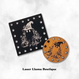 May include: Two wooden stitch markers with a laser-engraved design of a ghost wearing a witch hat and holding pumpkins. The design is in black and white on a natural wood background. The markers are round and square.