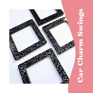 May include: Four black square car charm swings with a white glitter finish.  The charms have a square opening in the center.  Car Charm Swings.