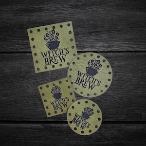May include: Four olive green leather patches with dark brown stitching holes along the edges. Two patches are square and two are circular. Each patch features a black graphic of a steaming cauldron and the text Witch's Brew printed in black.