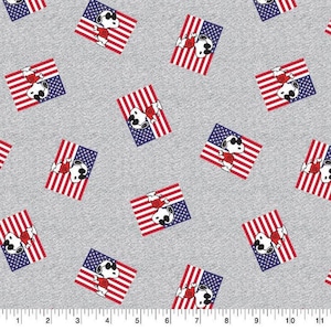 May include: A gray fabric with a repeating pattern of white, red, and blue American flags. Each flag features a cartoon dog wearing sunglasses and a red, white, and blue shirt.