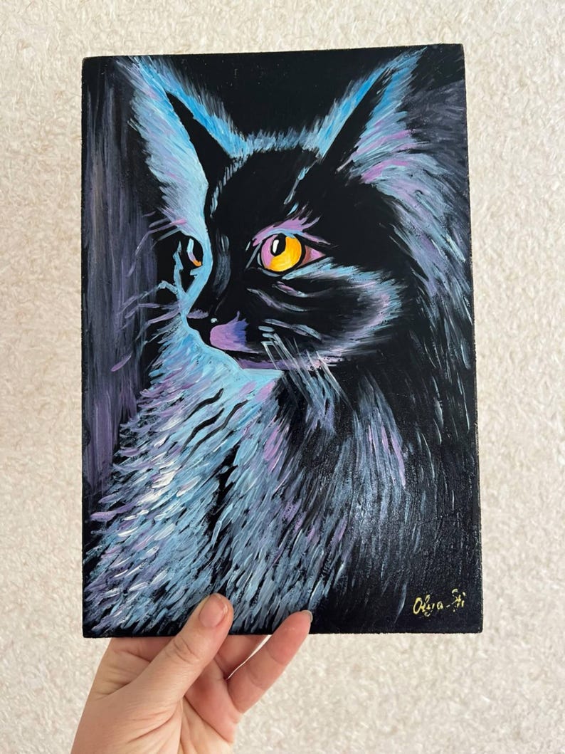 May include: A black cat with yellow eyes is painted on a black canvas. The cat's fur is painted with shades of blue, purple, and white. The artist's signature, "Olga", is in the bottom right corner.