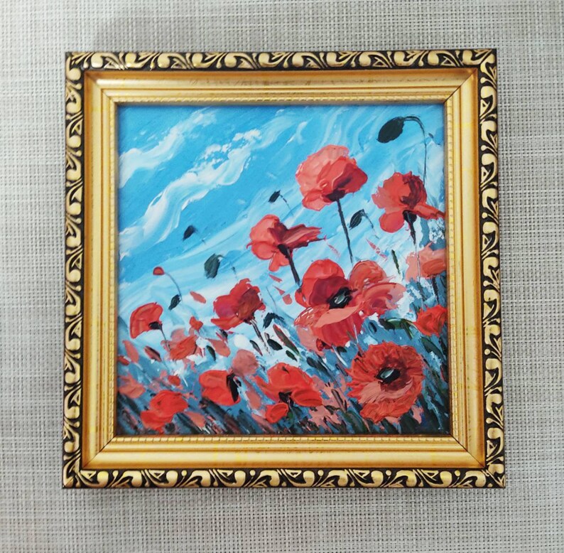 May include: A framed painting depicting red poppies against a blue sky with white clouds. The painting is executed in a loose, impressionistic style.