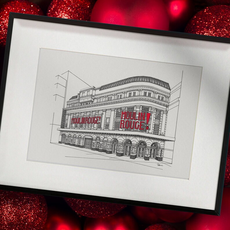 May include: A framed black and white sketch of the Moulin Rouge building, with the words "MOULIN ROUGE!" in red. The artwork is set against a backdrop of red Christmas baubles. The frame has a white mount.
