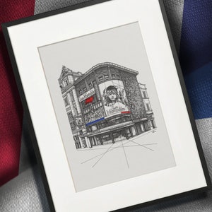 May include: A black and white line drawing of a building with a large billboard featuring a girl's face and the text "Les Mis&eacute;rables" in red. The building is drawn in a perspective view with a street in front of it.