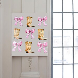 May include: A canvas print featuring a repeating pattern of watercolor cowboy boots and pink bows. The boots are tan with brown accents, and the bows are a soft pink. The background is a light gray.