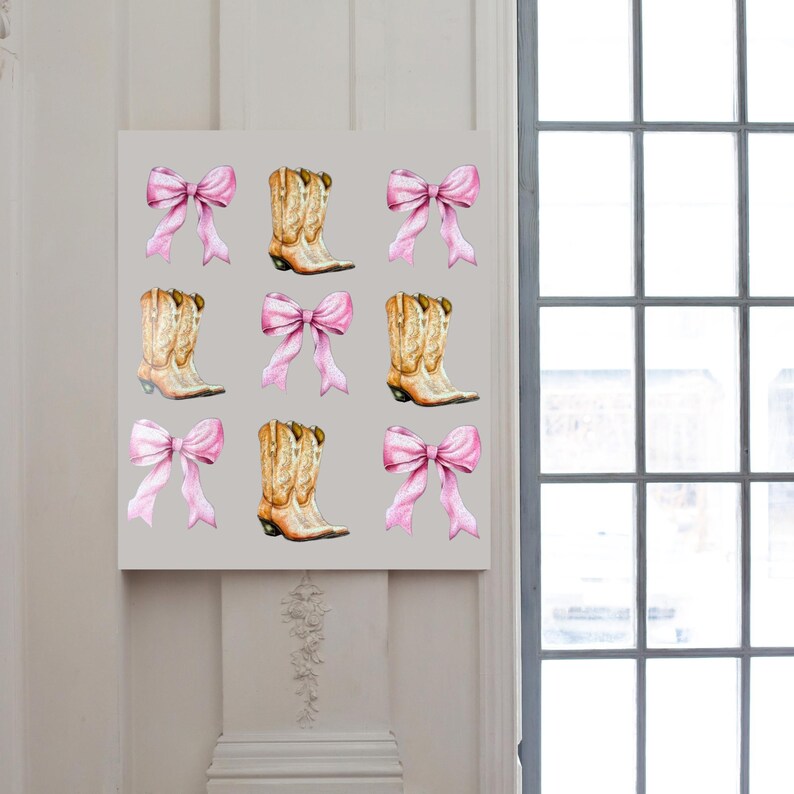 May include: A canvas print featuring a repeating pattern of watercolor cowboy boots and pink bows. The boots are tan with brown accents, and the bows are a soft pink. The background is a light gray.