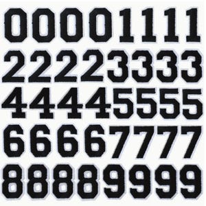 May include: Set of black felt iron-on numbers, 0-9, each number repeated five times. The numbers are outlined in white and have a slightly raised texture.
