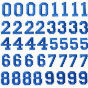 May include: Set of blue felt iron-on numbers, 0-9, with white outlines. Each number is repeated five times.