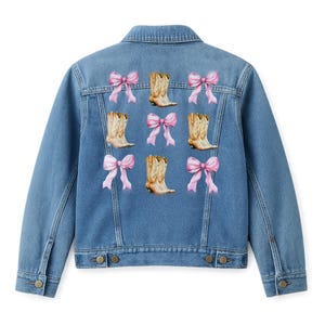 May include: A light blue denim jacket featuring a pattern of pink bows and cowboy boots. The boots are tan with brown accents. The jacket has a classic collar, button closures, and pockets.