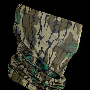 May include: A camouflage-patterned neck gaiter with a small logo in the center. The gaiter is made of a soft, breathable fabric and is designed to be worn around the neck, face, or head.