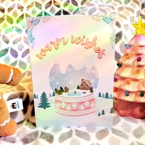 Biglietto di auguri di Buon Natale con palla di neve, paese delle meraviglie invernale, casa di pan di zenzero e famiglia