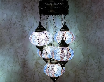 May include: A blue and white mosaic glass chandelier with five lights. The chandelier has a round, metal frame and is suspended from a chain.