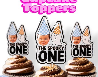 May include: Three cupcake toppers featuring a photo of a baby wearing a blue checkered party hat next to a cartoon ghost wearing an orange checkered party hat. The text THE SPOOKY ONE is printed in bold black letters at the bottom of each topper.