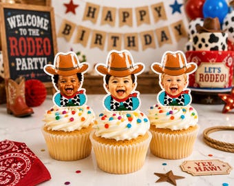 May include: Three cupcakes topped with white frosting and colorful sprinkles, each featuring a custom paper topper of a baby wearing a brown cowboy hat and a cow-print bandana. The toppers display smiling faces of three different infants.